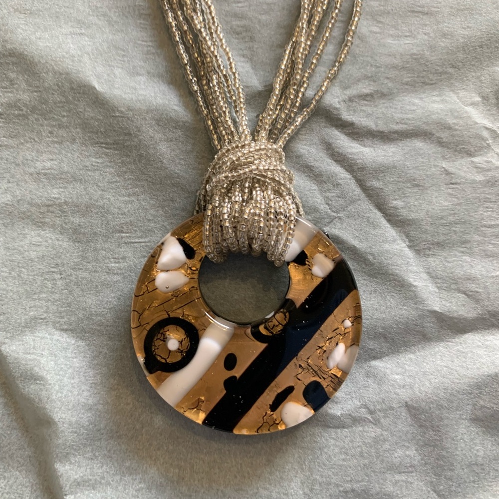 Silver beaded necklace with gold/white/black accent medallion